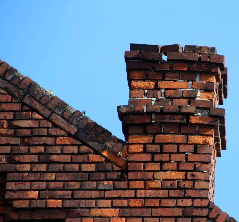 Signs Your Cerritos Home Needs a Chimney Inspection Damaged chimney on an Cerritos home showing cracks and missing mortar